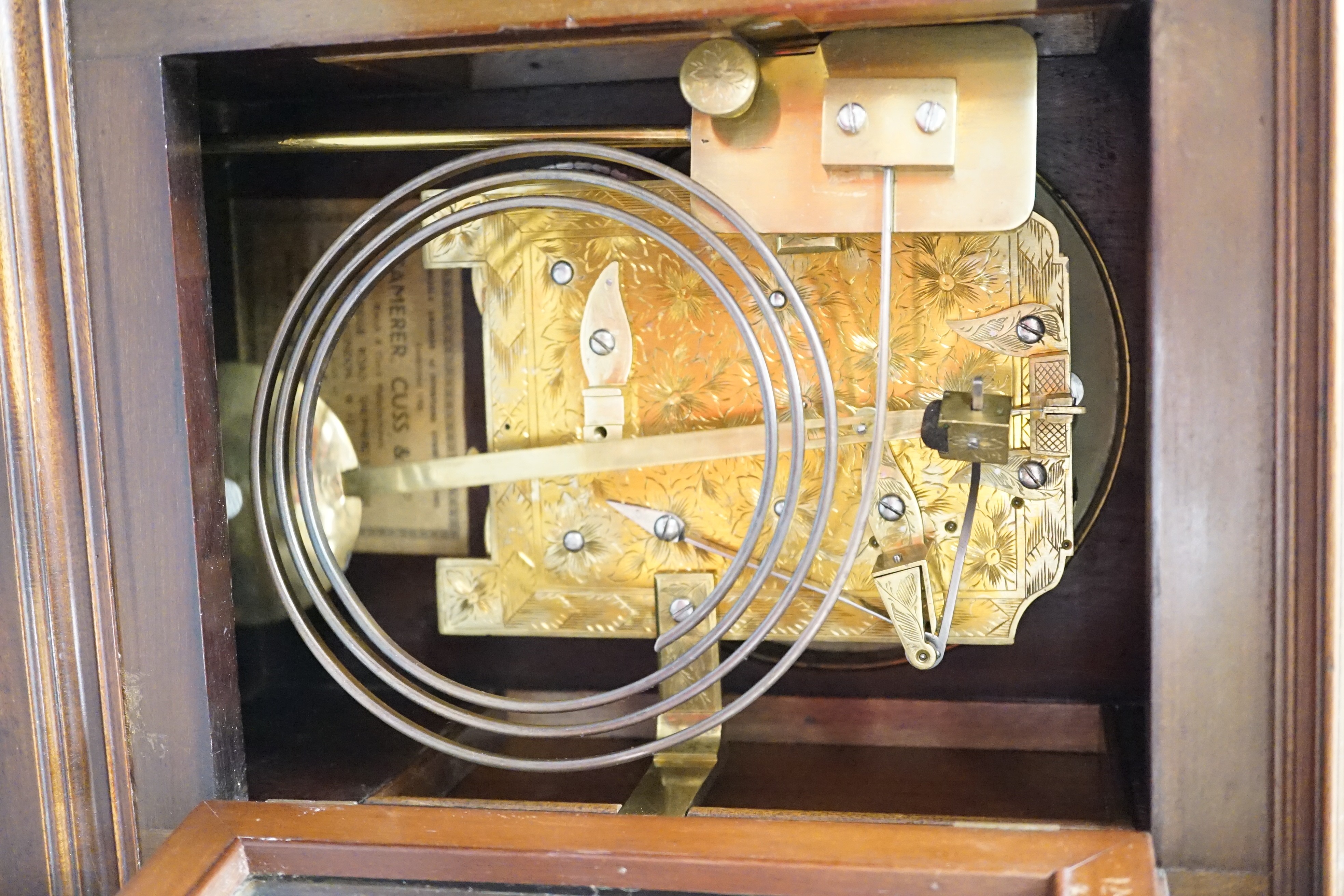 A Regency brass inlaid mahogany bracket clock, with pineapple finial, bears interior paper label Cuss & Co. 49cm high